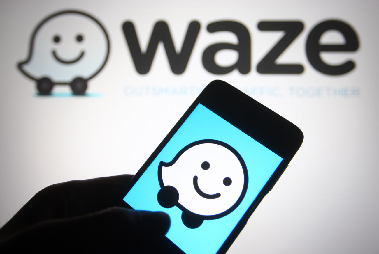 Waze logo on smartphone illustration for article about Waze AI features